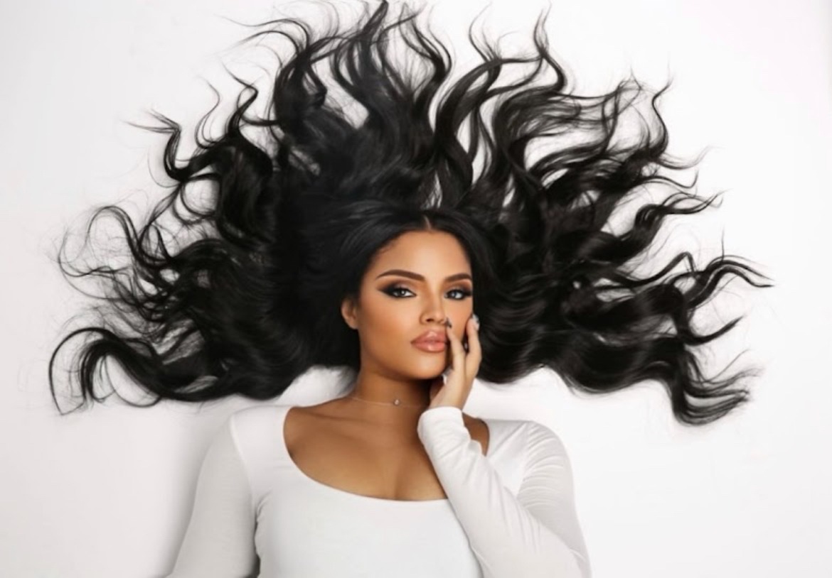 Collab Beauty Studio editorial portrait — dramatic flowing black hair fanned around the face